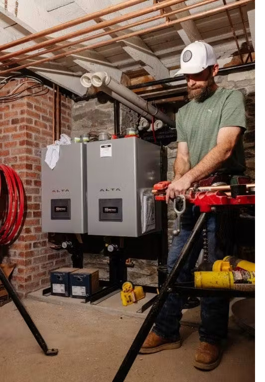 Two ALTA boilers on stands in basement