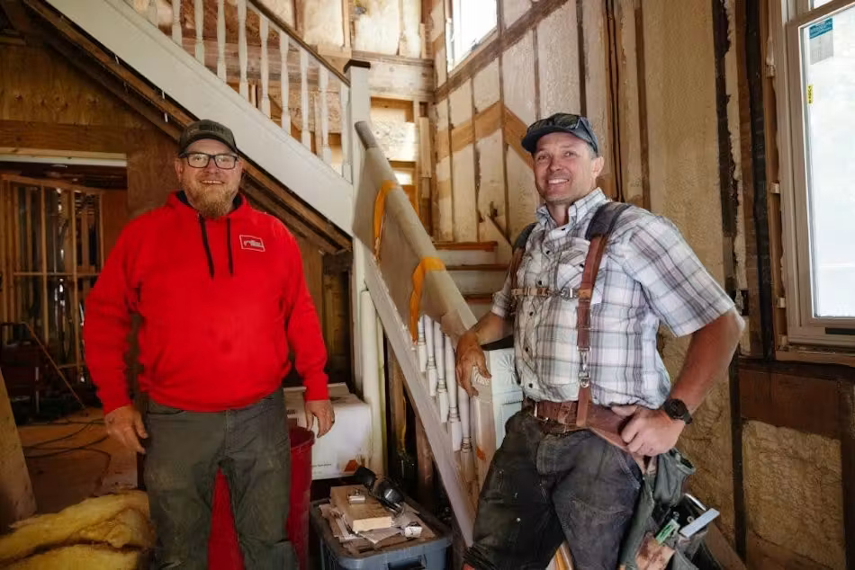 Contractors Nathan Bailey and Drew Coubrough inside house during renovations